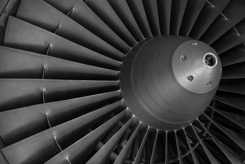 turbine-aircraft-motor-rotor-40024-40024 Detailed black and white image of an airplane turbine engine showcasing blades and craftsmanship.